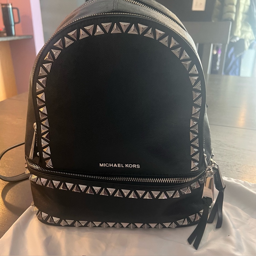 Includes a FREE MK wallet with purchase! MK Rhea Medium Studded Leather Backpack